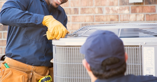 technicians working on outside AC unit