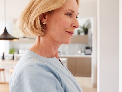 Woman using thermostat